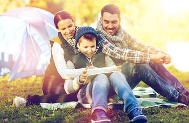 Image showing happy family with tablet pc and tent at camp site