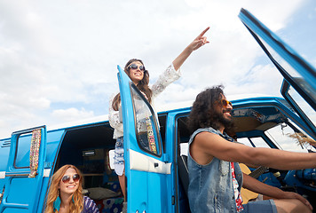 Image showing smiling happy young hippie friends at minivan car