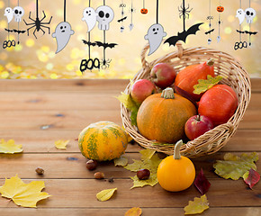 Image showing pumpkins in basket and halloween party garland