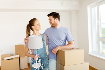 Image showing couple with boxes and lamp moving to new home