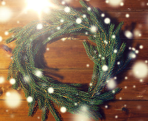 Image showing natural green fir branch wreath on wooden board