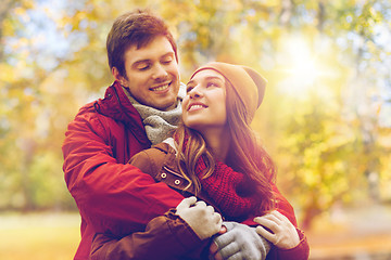 Image showing happy young couple hugging in autumn park