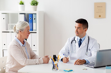 Image showing woman and doctor with prescription at clinic