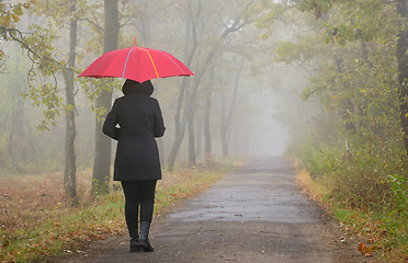 Image showing Depressed woman with red umbrella