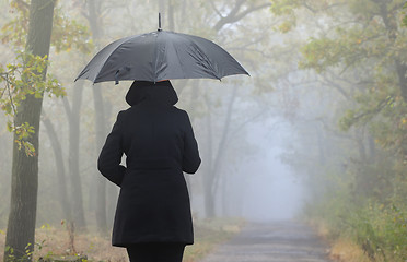 Image showing Depressed woman with red umbrella