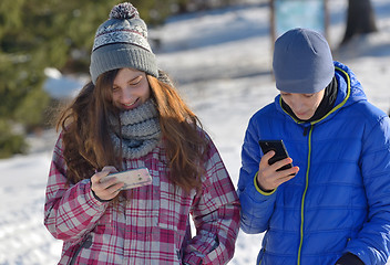 Image showing Kids with Smartphone in winter forest