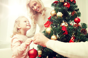 Image showing happy family decorating christmas tree at home