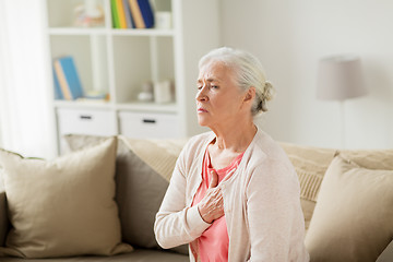 Image showing senior woman suffering from heartache at home