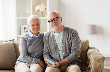 Image showing happy senior couple sitting on sofa at home