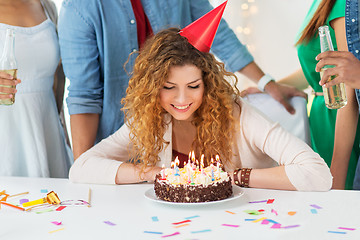 Image showing happy woman with birthday cake at home party