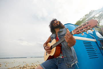 Image showing hippie man playing guitar at minivan car outdoor