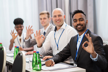 Image showing people at business conference showing ok hand sign