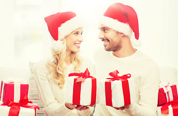 Image showing happy couple at home exchanging christmas gifts