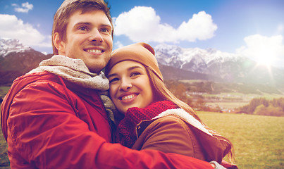 Image showing happy young couple hugging over alps mountains