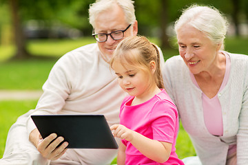 Image showing grandparents and granddaughter with tablet pc