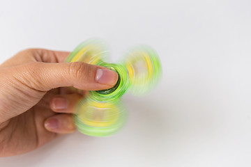 Image showing close up of hand playing with fidget spinner