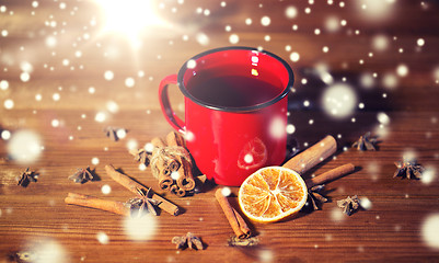 Image showing close up of tea cup with spices on wooden table