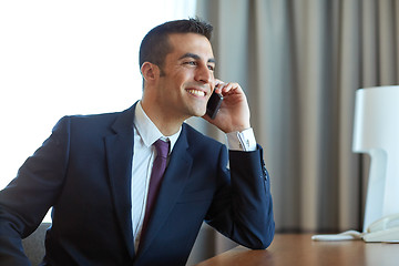 Image showing businessman calling on smartphone at hotel room