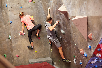 Image showing man and woman training at indoor climbing gym wall