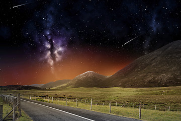 Image showing night landscape of road and mountains over space