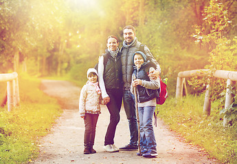 Image showing happy family with backpacks hiking