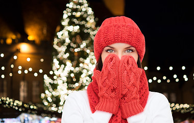 Image showing young woman in winter clothes over christmas tree