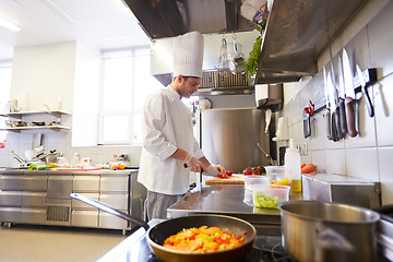 Image showing male chef cooking food at restaurant kitchen