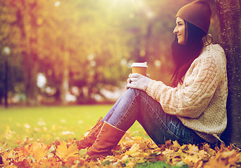 Image showing close up of woman drinking coffee in autumn park