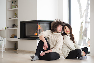 Image showing happy multiethnic couple  in front of fireplace