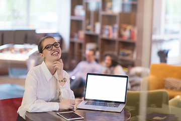 Image showing businesswoman using a laptop in startup office