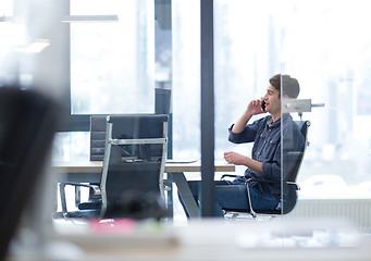 Image showing Young casual businessman using smartphone