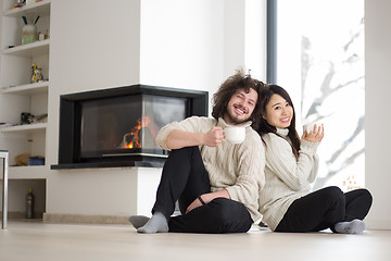 Image showing happy multiethnic couple  in front of fireplace