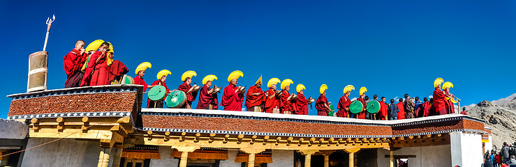 Image showing Monks in row on roof in Ladakh