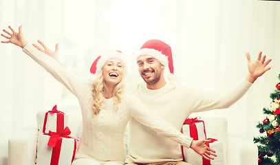 Image showing happy couple at home with christmas gift boxes