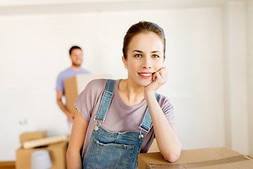 Image showing happy couple with boxes moving to new home