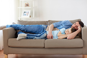 Image showing happy father and son sleeping on sofa at home