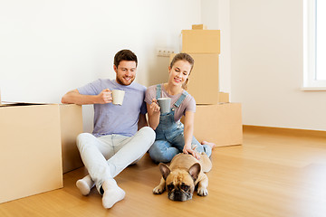 Image showing happy couple with boxes and dog moving to new home