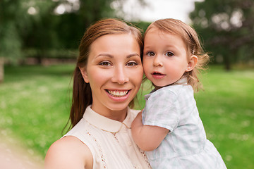 Image showing mother with baby girl taking selfie at summer park