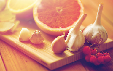 Image showing citrus, ginger, garlic and rowanberry on wood