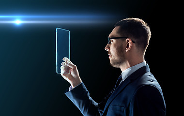 Image showing businessman working with transparent tablet pc