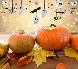 Image showing pumpkins with autumn leaves and halloween garland