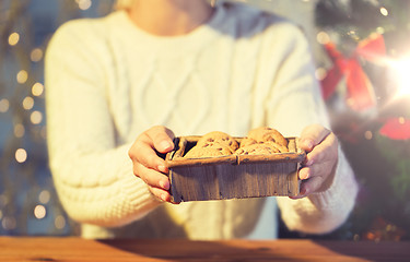 Image showing close up of woman with oat cookies at home