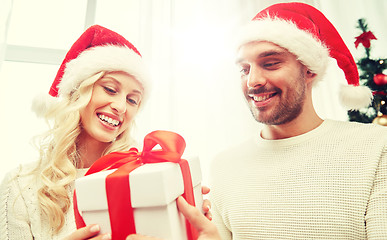 Image showing happy couple at home with christmas gift box