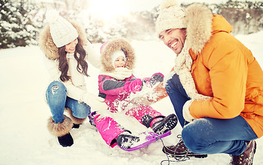 Image showing happy family with kid on sled having fun outdoors