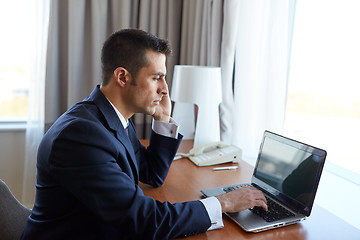 Image showing businessman with laptop and smartphone at hotel