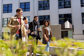 Image showing people with coffee and conference badges in city