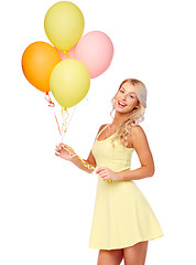 Image showing happy woman in dress with helium air balloons