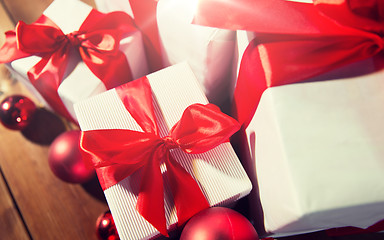 Image showing close up of gift boxes and red christmas balls