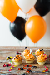 Image showing halloween party cupcakes and candies on table