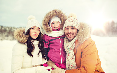 Image showing happy family with child in winter clothes outdoors